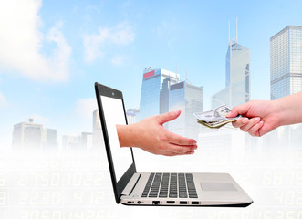Get money from online business holding US dollar in hand.business concept on urban background.