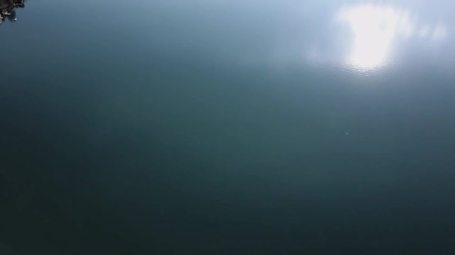 Drone flying over lake W&ouml;rthersee and showing town by the water in K&auml;rnten, Austria.
