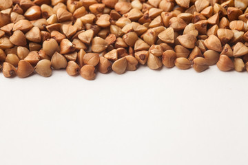 Raw buckwheat on white background