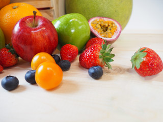 Colorful fresh fruits and vegetables on wood background, healthy eating concept.
