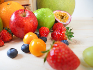 Colorful fresh fruits and vegetables on wood background, healthy eating concept.