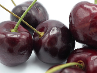 Fresh sweet cherry in shopping cart or trolly isolated on white background.