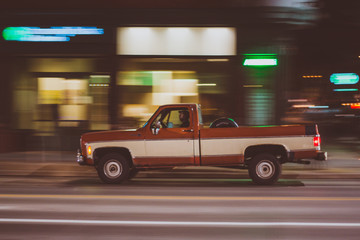 Fototapeta na wymiar Vintage truck driving in downtown 