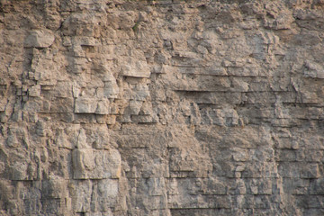 Closeup limestone rock face showing weathered strata Geology walpaper or background - obrazy, fototapety, plakaty