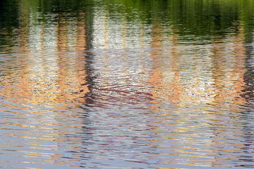 Fototapeta na wymiar Reflection of a building on the lake as abstract background