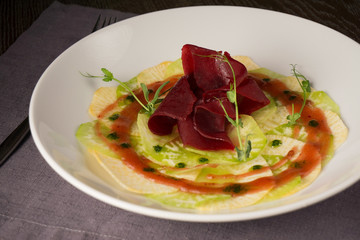 Modern beet salad with turnips and green sauce for vegetarians