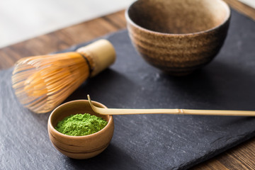 green matcha tea prepearing on stone black table 