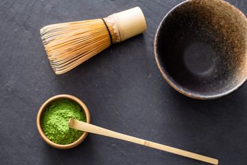 green matcha tea prepearing on stone black table 