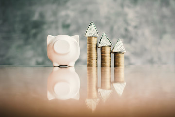 White piggy bank and coin on wood, Concept save money for residence