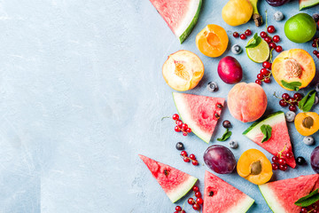 Summer vitamin food concept, various fruit and berries watermelon peach mint plum apricots...