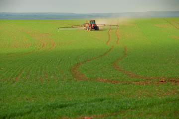 Fototapeta na wymiar Tractor spraying chemicals