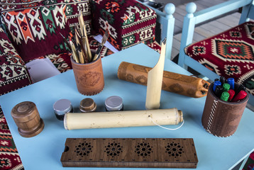 Set of tools for calligraphy Arab master on background of Arab carpets