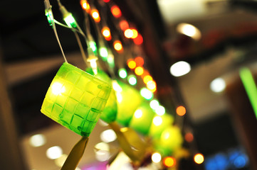 a string of colorful lighting with small bulbs in ketupat decoration, bokeh effect