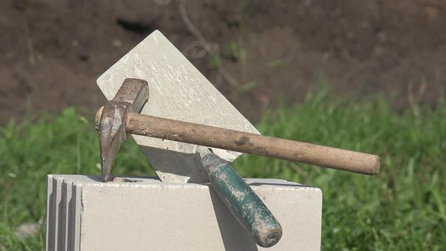 hammer and mason's trowel on masonry