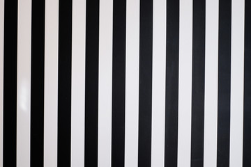 Stripe of black color on white wall background.
