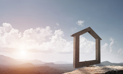 Conceptual image of concrete home sign on hill and natural landscape at background