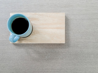 A cup of coffee with wooden tray