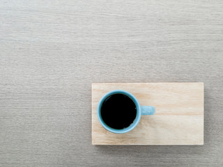 A cup of coffee with wooden tray