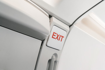 emergency exit sign on airplane. Empty airplane seats in the cabin. Modern Transportation concept. Aircraft long-distance international flight