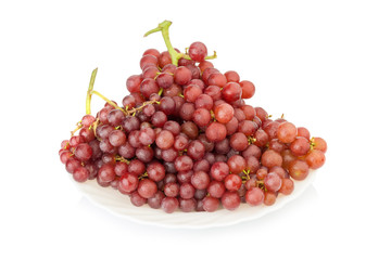 grapes seedless red on dish isolated on white background