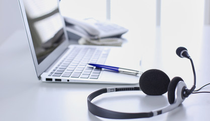 Communication support, call center and customer service help desk. VOIP headset on laptop computer...