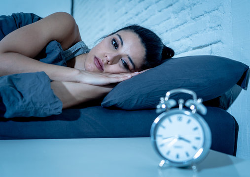 pretty latin woman can't sleep in insomnia concept