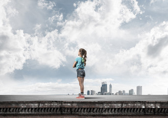 Concept of careless happy childhood with girl looking far away