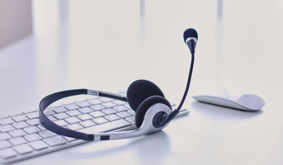 Communication support, call center and customer service help desk. VOIP headset on laptop computer keyboard