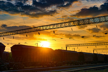 railroad infrastructure during beautiful sunset and colorful sky, railcar for dry cargo,...