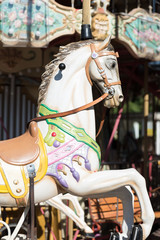 Fototapeta na wymiar White horses of the antique carousel
