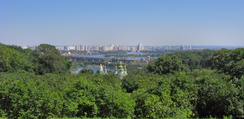 Fototapeta na wymiar grandiose panorama of high-rise city blocks on the domes of the church