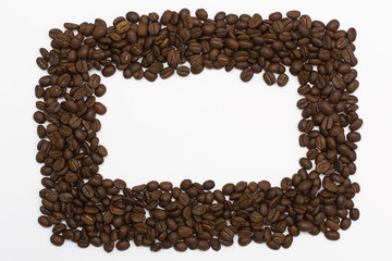 Background of coffee beans. Coffee texture. A place to write a text. Cinnamon sticks and cardamom.