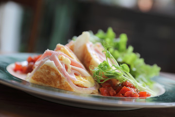 Breakfast burrito ham and eggs with salad vintage style