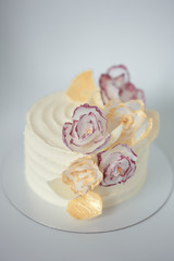 white cake on a white background with a wafer flowers
