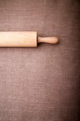 Baking ingredients. Flour, eggs, wheat and rolling pin on  table cloth. Rustic. Copy space