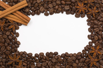 Background of coffee beans. Coffee texture. A place to write a text. Cinnamon sticks and cardamom.
