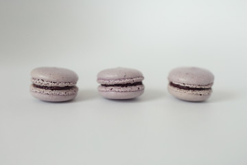 violet macaroons with violet creme on white background