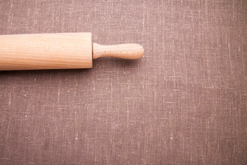 Baking ingredients. Flour, eggs, wheat and rolling pin on  table cloth. Rustic. Copy space