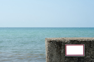 Prohibiting empty insulated sign installed on the pebble beach of the pier