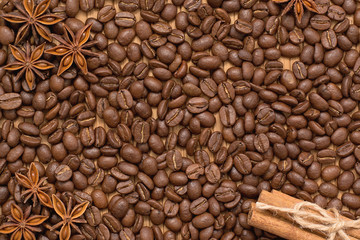 Background of coffee beans. Coffee texture. Cinnamon sticks and cardamom.