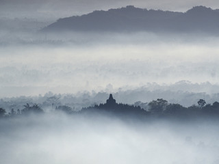 Borobudur Temple in a beautiful foggy sunrise seen from Punthuk Setumbu Hill