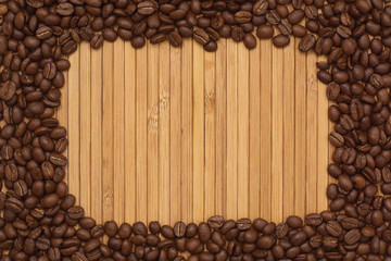 Background of coffee beans. Coffee texture. A place to write a text. Cinnamon sticks and cardamom.