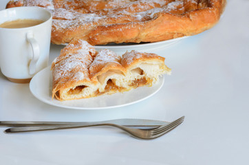 Ensaimada and cup of coffee.  Ensaimada is traditional pastry  in Mallorca, Balearic, Islands  and  one of the most iconic pastries in Spain eating at breakfast, snack time and dessert.