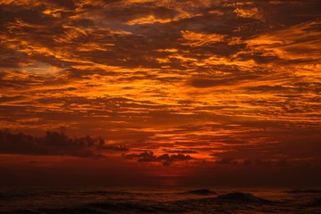 the last hour on the first day - red, orange colored cloudy sunset over the Indian ocean