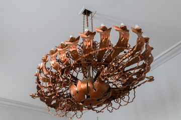 Copper chandelier handmade from thin platelets chains in vintage style