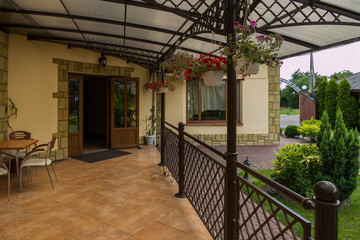 a table for rest under a canopy of a beautiful cafe with a modern renovation © adamchuk_leo