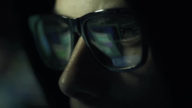 Hacker with glasses connecting online and stealing data