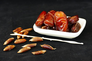 palm and palm kernel on a black background,
