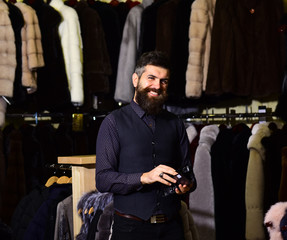 Fototapeta na wymiar Man with beard and mustache in fashion fur shop.