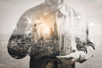 Double exposure of success businessman using digital tablet with London building,filter effect